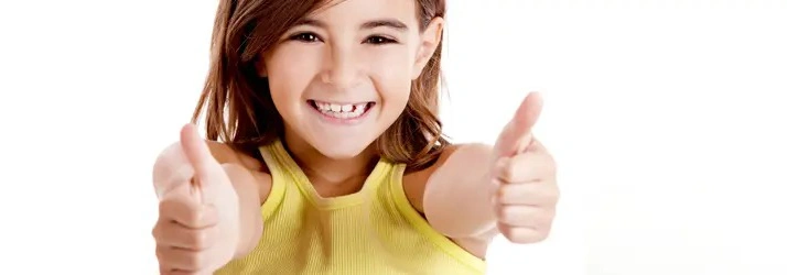Child wearing a sleeveless yellow top giving two thumbs up