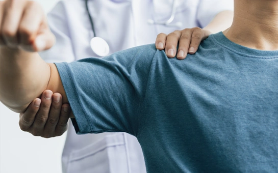 A healthcare professional gently guiding and supporting a person’s arm